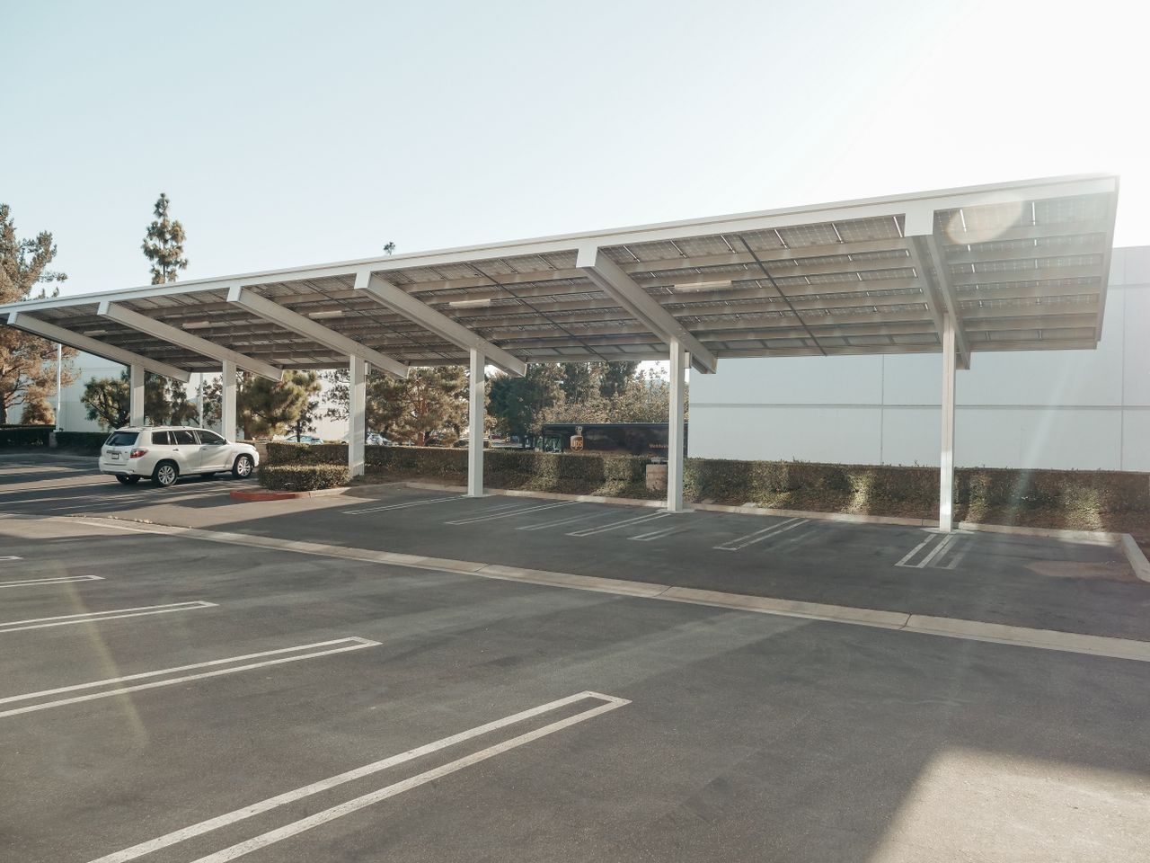 Solar panels installed over a parking lot, showcasing clean energy innovation outdoors.